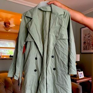 Trench-style coat. Looks like a trench coat but is not trench coat material.